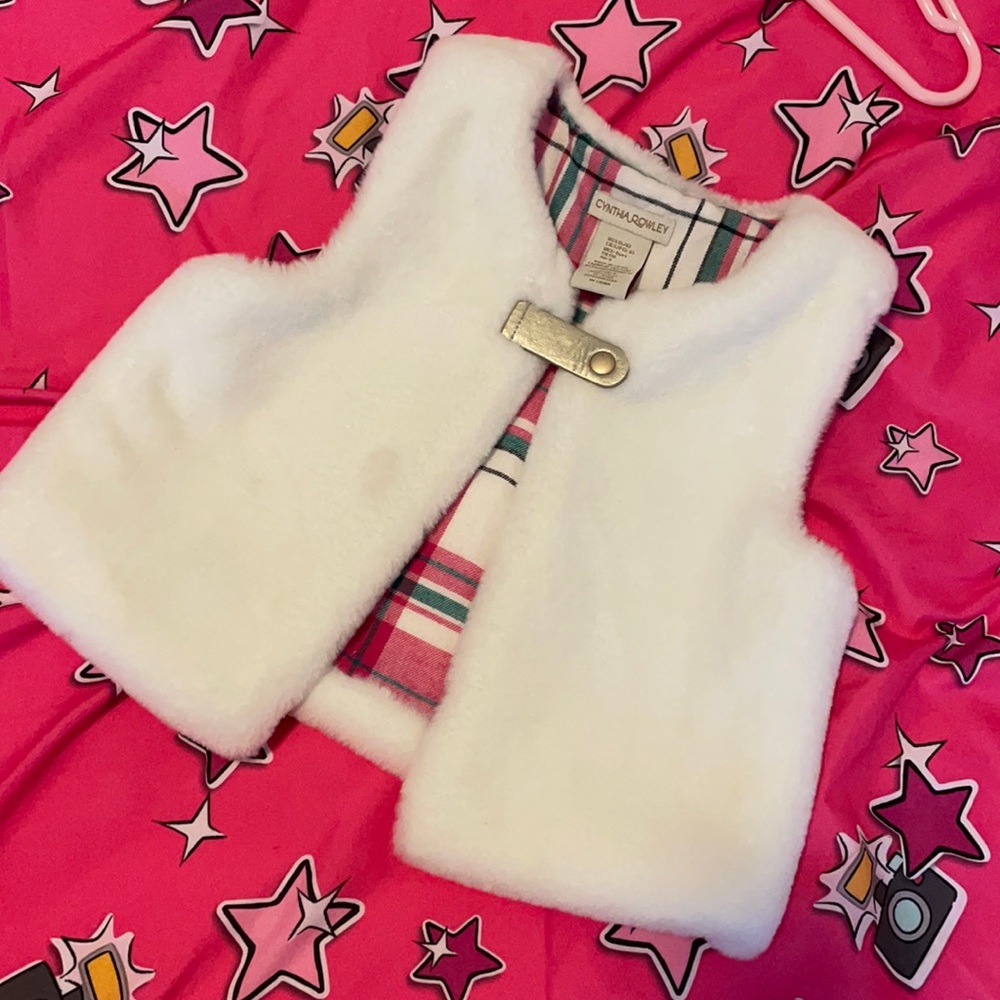 Faux fur vest with small imperfection but can easily be hand washed off.